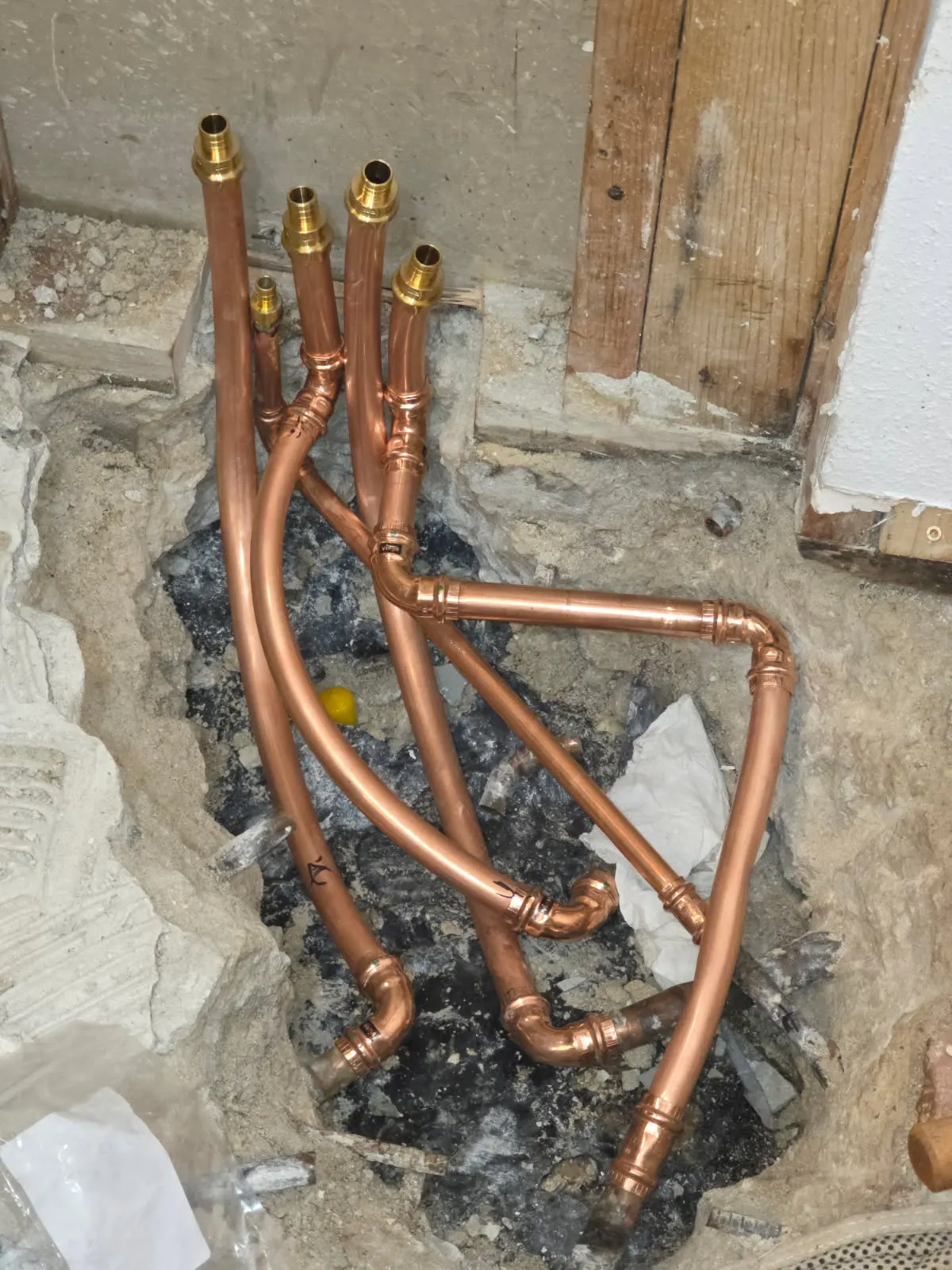 After: new copper water lines with modern press fittings re-routed through the concrete slab by Out This World Services